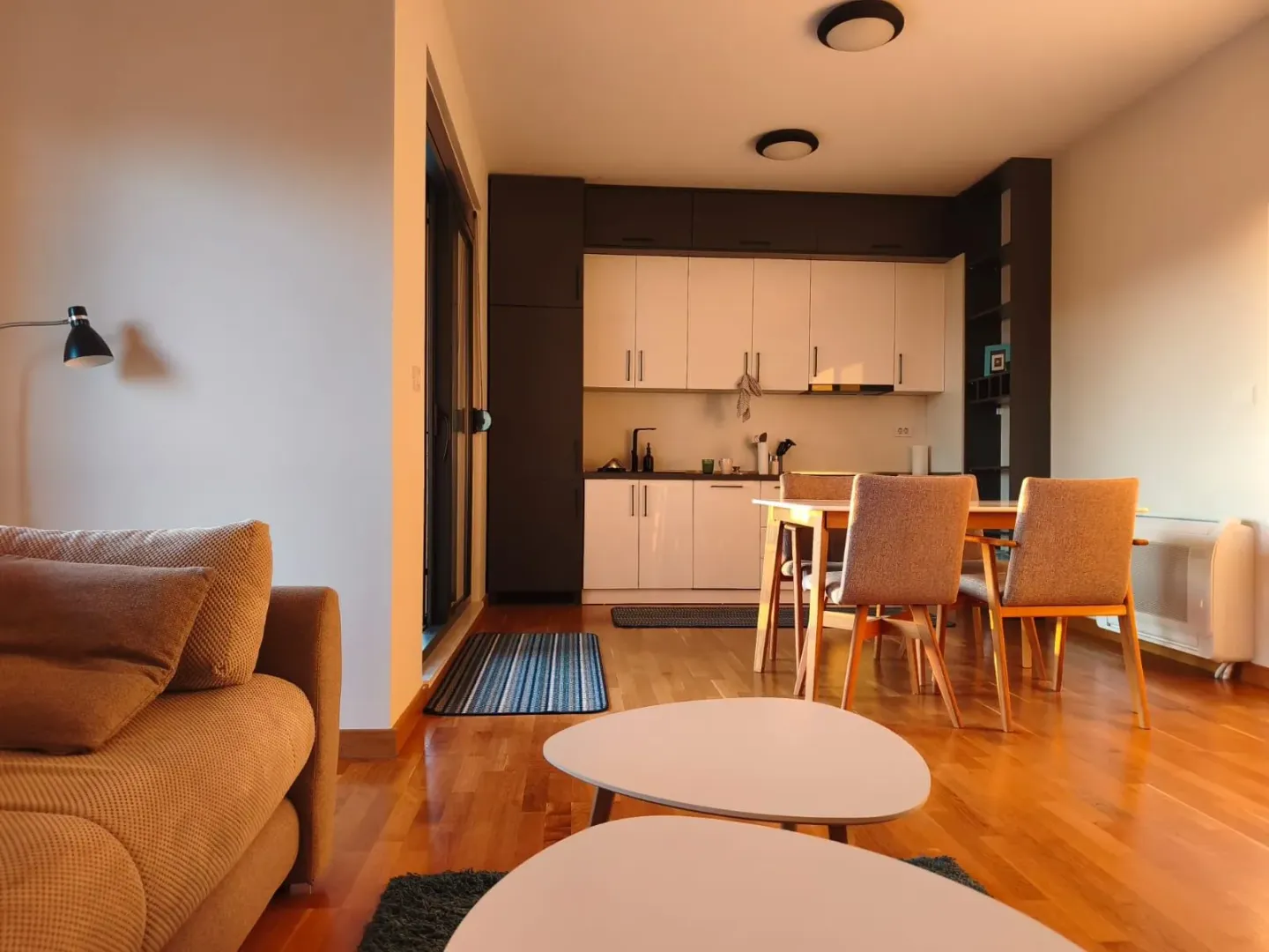 Living room with a dining area and kitchen in an open plan space.