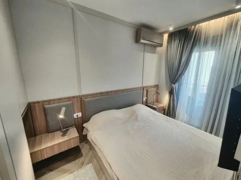 Modern bedroom with a double bed, bedside tables and air conditioning. - image 8