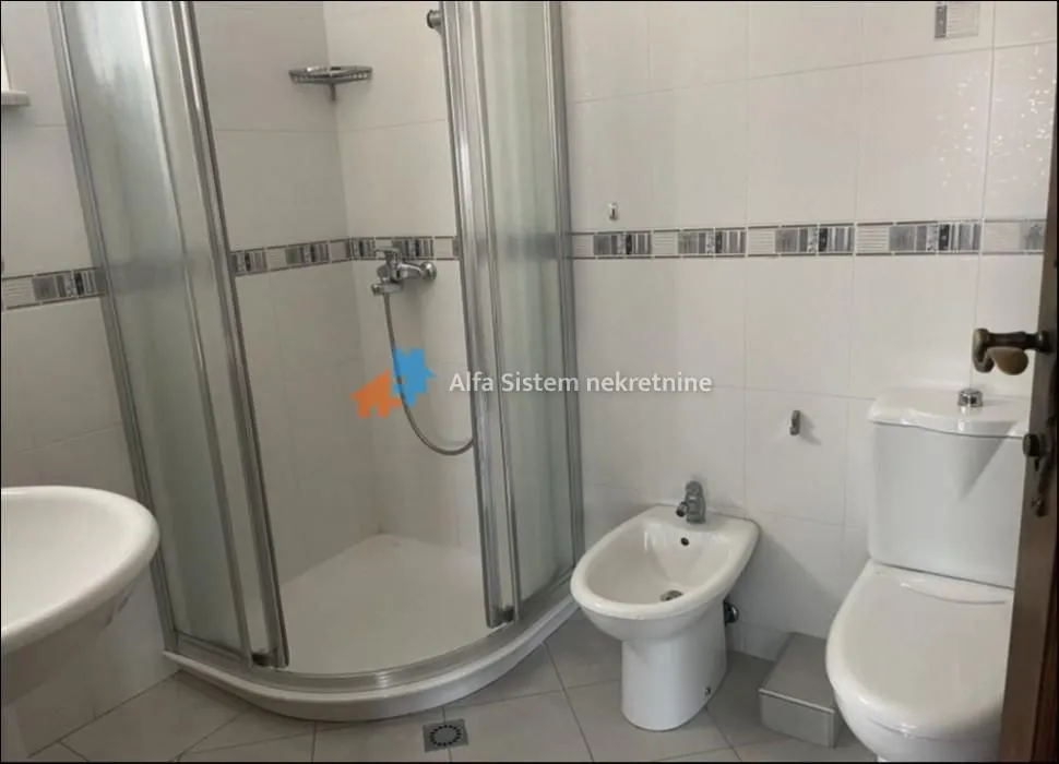 Bathroom equipped with a shower cabin, washbasin, bidet, and toilet.