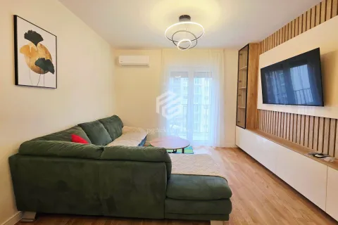 Living room with a comfortable green sectional sofa, TV, and access to the terrace. - image 12