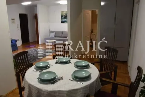 Dining area with a table and chairs overlooking the living room. - image 3