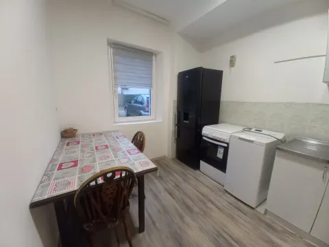 Kitchen with a dining table and basic household appliances. - image 2