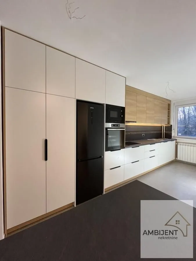 Modern kitchen with built-in cabinetry and refrigerator.