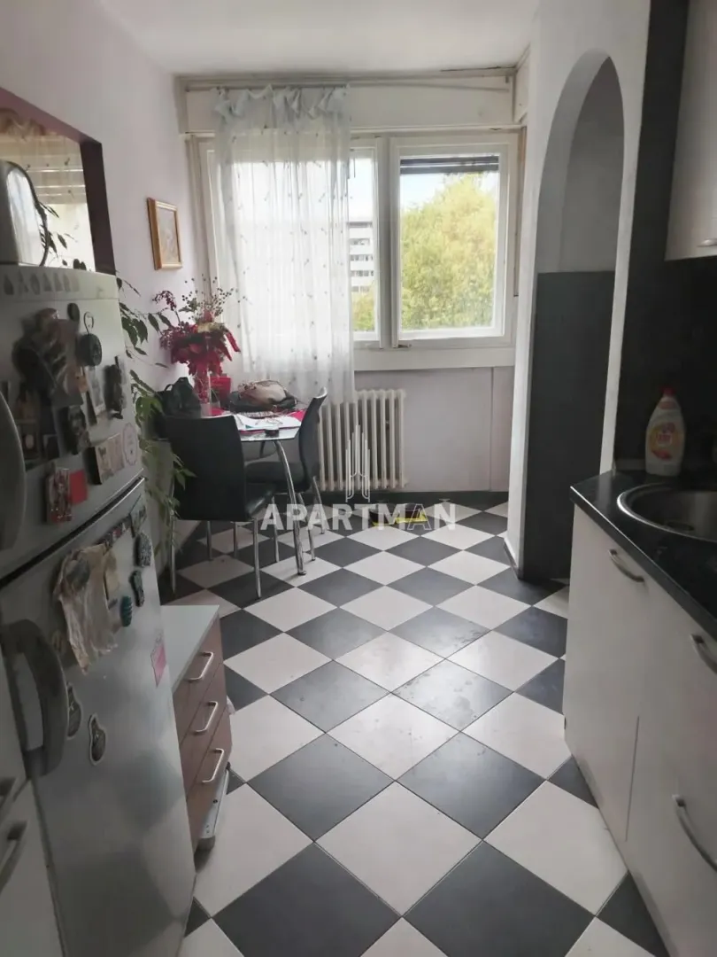 Small kitchen with a dining table by the window.