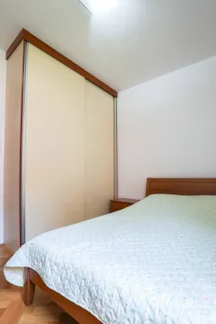 Tidy bedroom with a double bed and a fitted wardrobe. - image 7