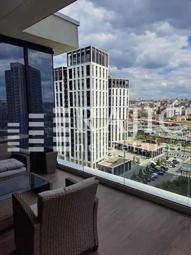 Modern terrace with seating furniture and a city view.