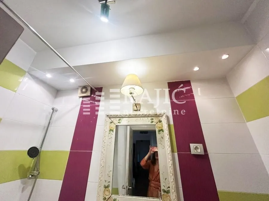 View of the bathroom with a mirror and shower cabin.