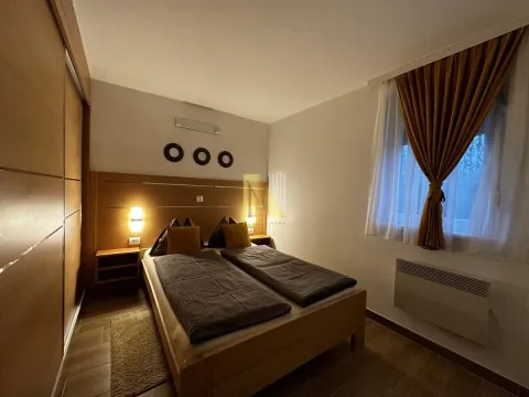 Furnished bedroom with a double bed and built-in wardrobe. - image 8
