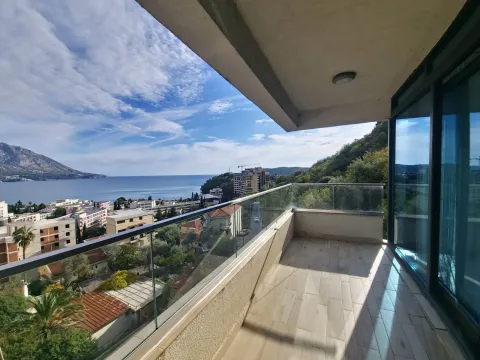 Spacious covered balcony with a glass railing and a view of the sea and surroundings. - image 9