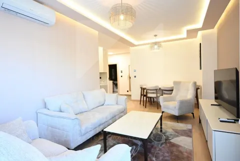 Living room with sofa set, television, and dining area in the background. - image 18