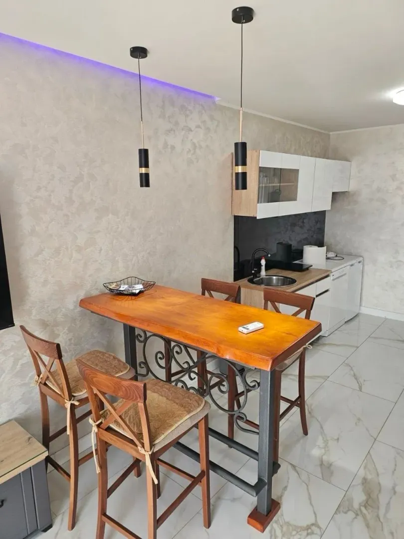 Smaller kitchen with a dining table and chairs.