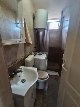Smaller bathroom with a washbasin, toilet, water heater and shower cabin. - image 8