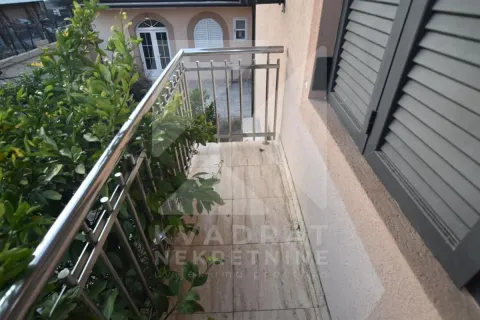 Balcony with metal railing and yard view. - image 21