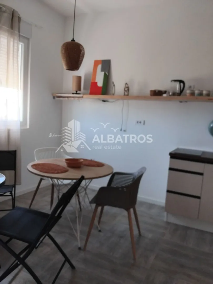 Small kitchen with a dining table and chairs.
