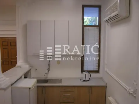 Small kitchen with wooden lower cabinets and white upper cabinets. - image 9