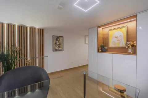 Modern living room interior with wooden wall paneling and built-in units. - image 11