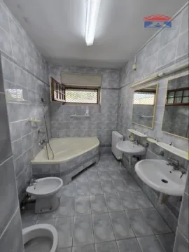 Spacious bathroom with a bathtub, two washbasins, and sanitary fixtures. - image 15