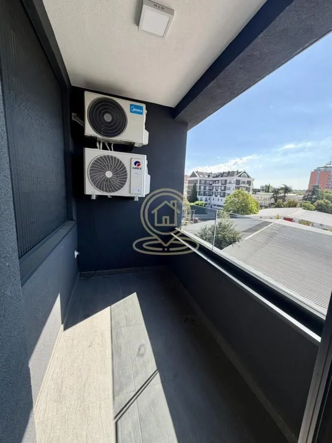 Balcony with outdoor air conditioning units and a view of the surroundings.