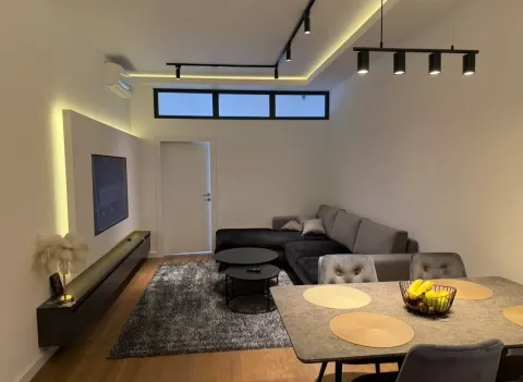Modern and tidy living room with a sofa set and dining table. - image 2