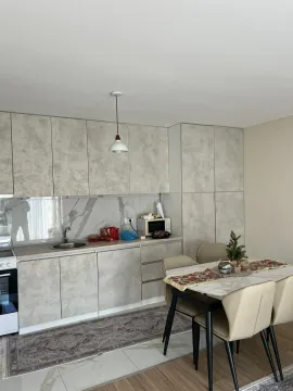 Bright kitchen with a dining table. - image 16