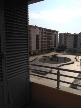 View from the balcony overlooking surrounding residential buildings and a playground. - image 12