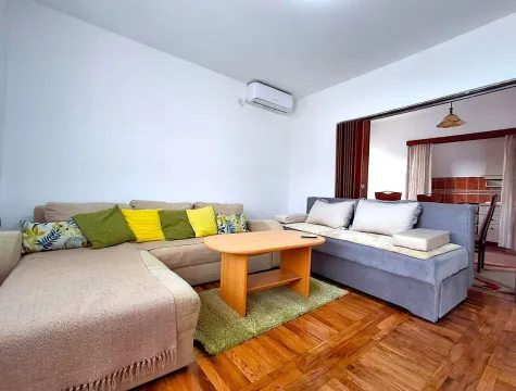 Bright living room with two sofas and a wooden coffee table. - image 5