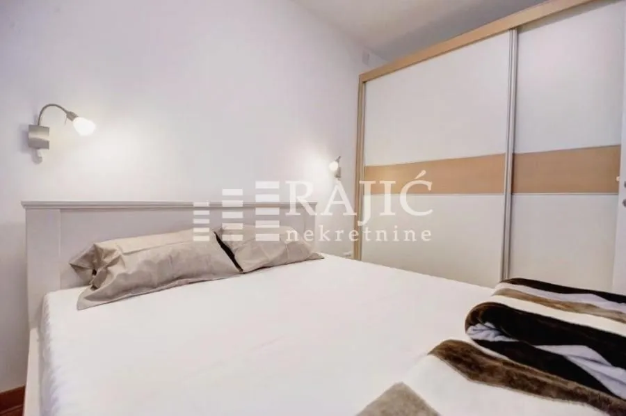 Bright bedroom with a double bed and a fitted wardrobe.
