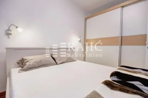 Bright bedroom with a double bed and a fitted wardrobe. - image 2