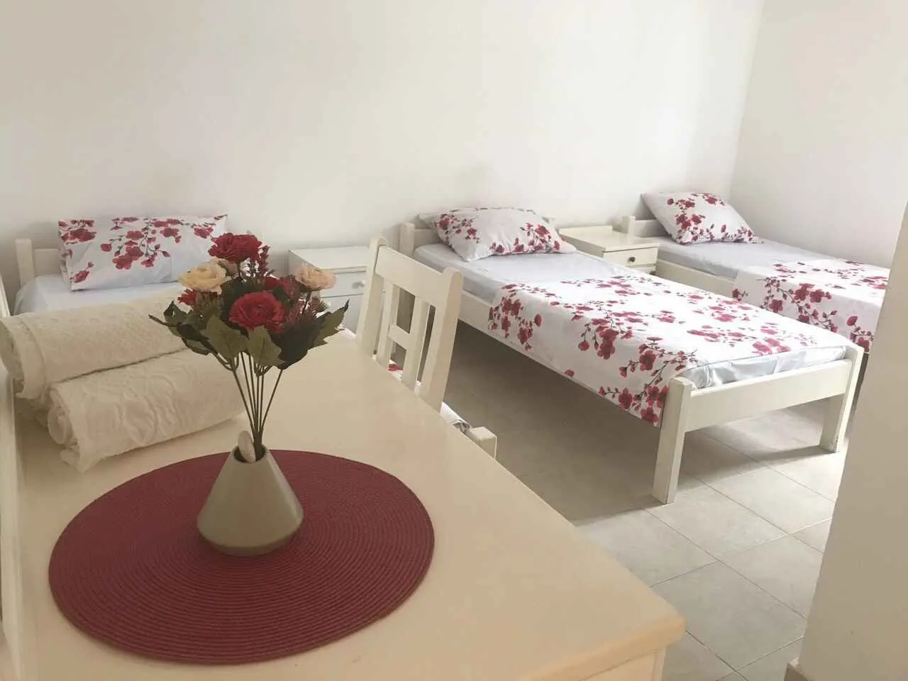 Bright bedroom with three single beds.