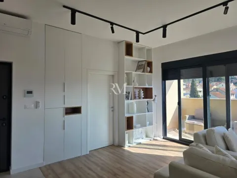 Bright living room with built-in closets, white shelving unit and access to the terrace. - image 6