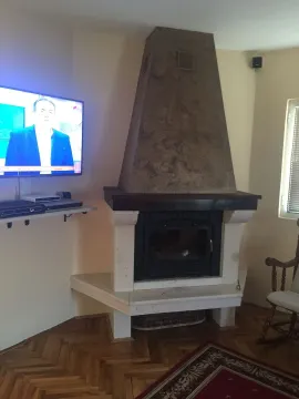 Part of a living room featuring a fireplace and a wall-mounted TV. - image 19