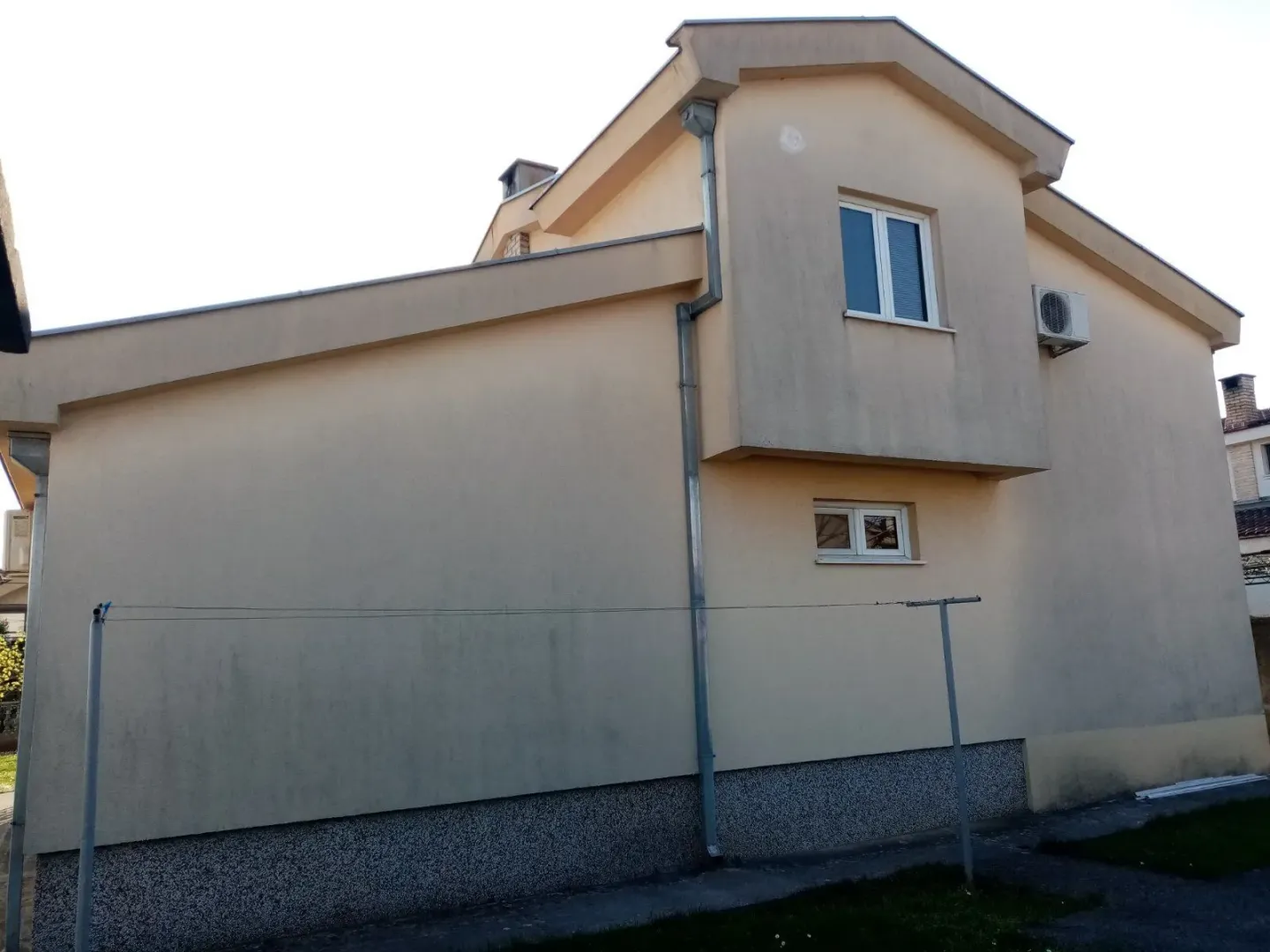 Exterior view of a two-story house with a beige facade.