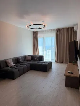 Modern and tidy living room with a sectional sofa and access to the terrace. - image 2