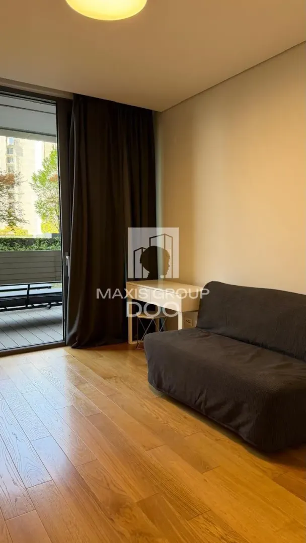 Small living room with a sofa and access to the terrace.