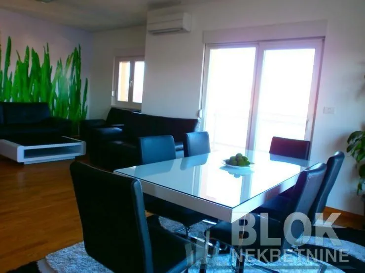 Living room with dining area and sofa set.