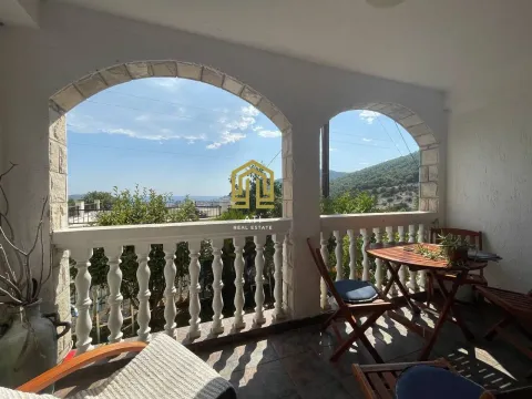 Covered terrace with stone arches and seating furniture overlooking nature. - image 5