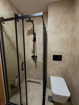 Modern bathroom with a shower cabin and built-in sanitaryware. - image 6