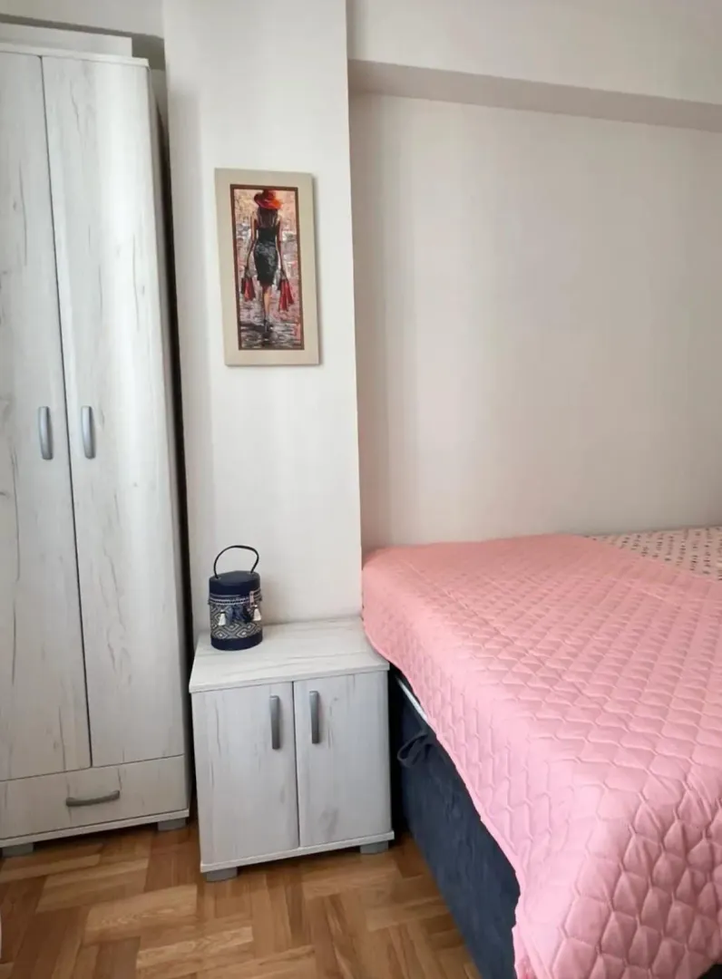 Small bedroom with a bed, wardrobe and a nightstand.