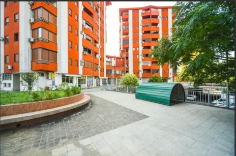 View of the courtyard and the facade of the orange residential buildings. - image 2