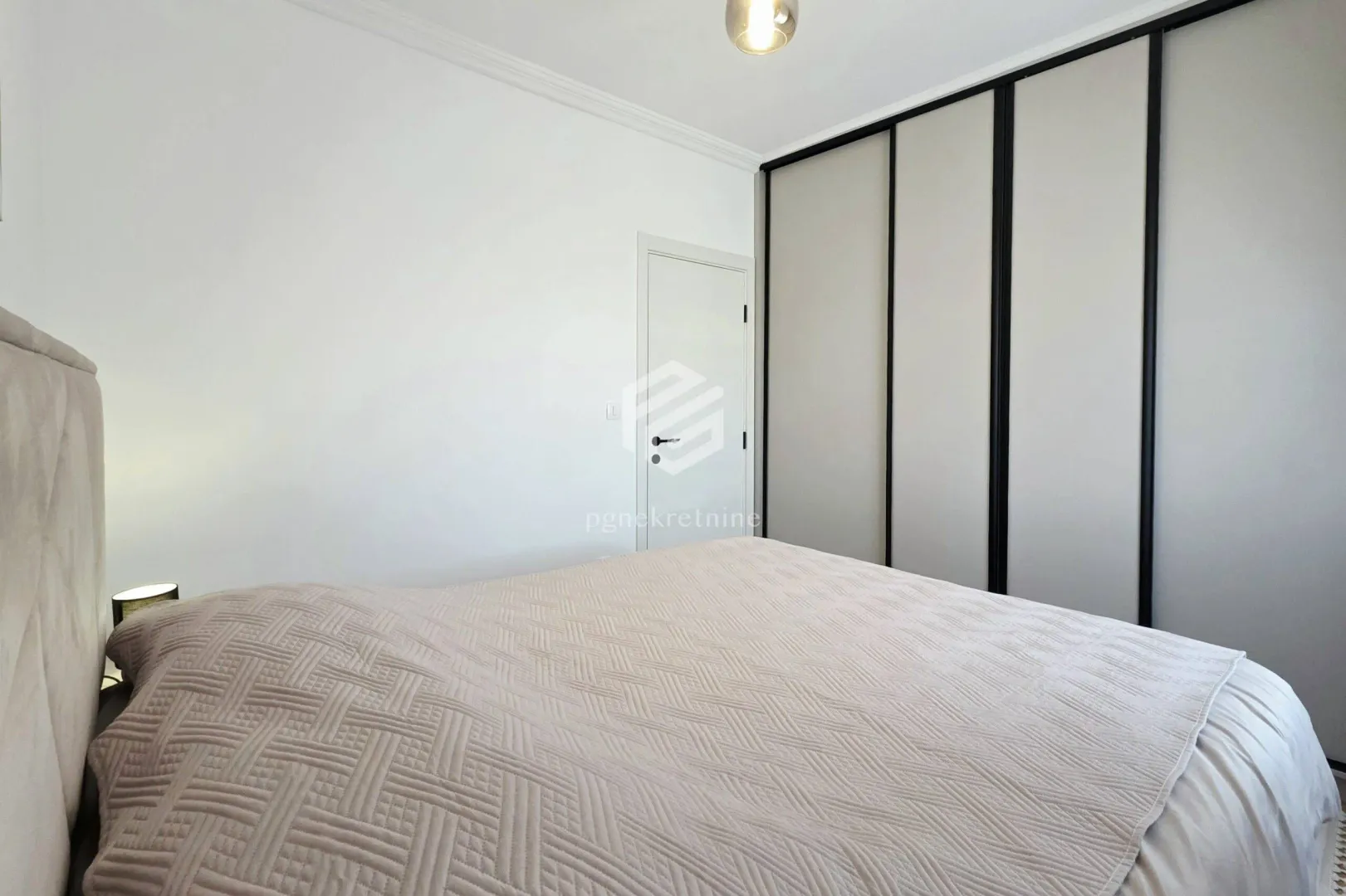 Bedroom with a double bed and a built-in wardrobe.