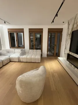 Spacious living room with a sofa set and a TV wall. - image 12