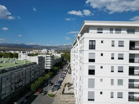 Aerial view of a modern apartment building and surrounding street. - image 22