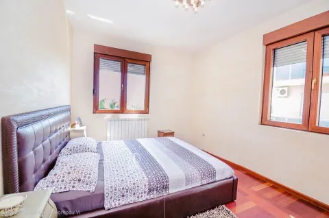 Furnished bedroom with a double bed and windows. - image 8
