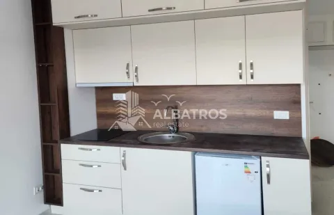 Small kitchen with white cabinets, dark countertop and a refrigerator. - image 4