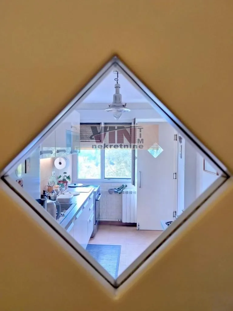 View of the kitchen through a decorative wall mirror.