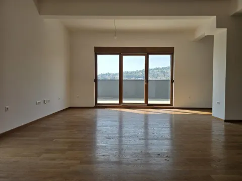 Empty room with hardwood floors and large balcony doors. - image 8