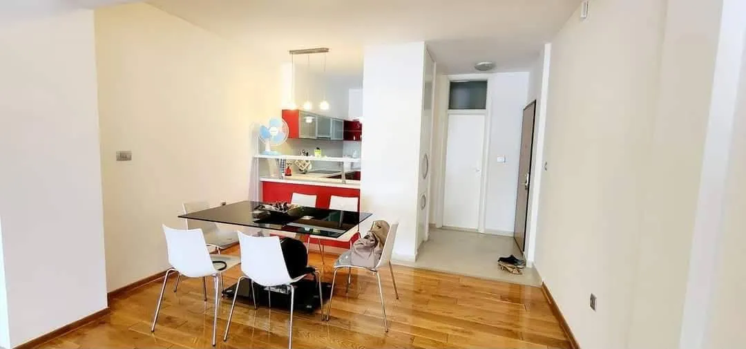 Living room with dining area and view of the kitchen.