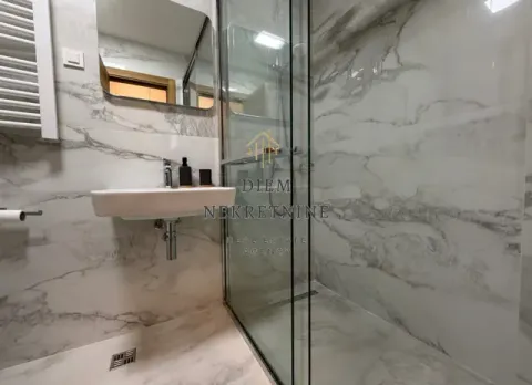 Modernly equipped bathroom with a walk-in shower and washbasin. - image 15