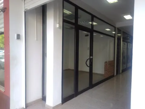 Entrance to a commercial space with glass doors and black frames. - image 6