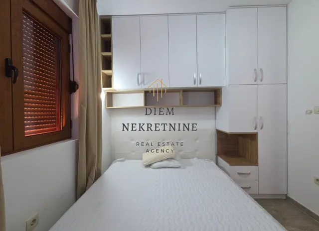 Furnished bedroom with built-in wardrobes and a double bed.